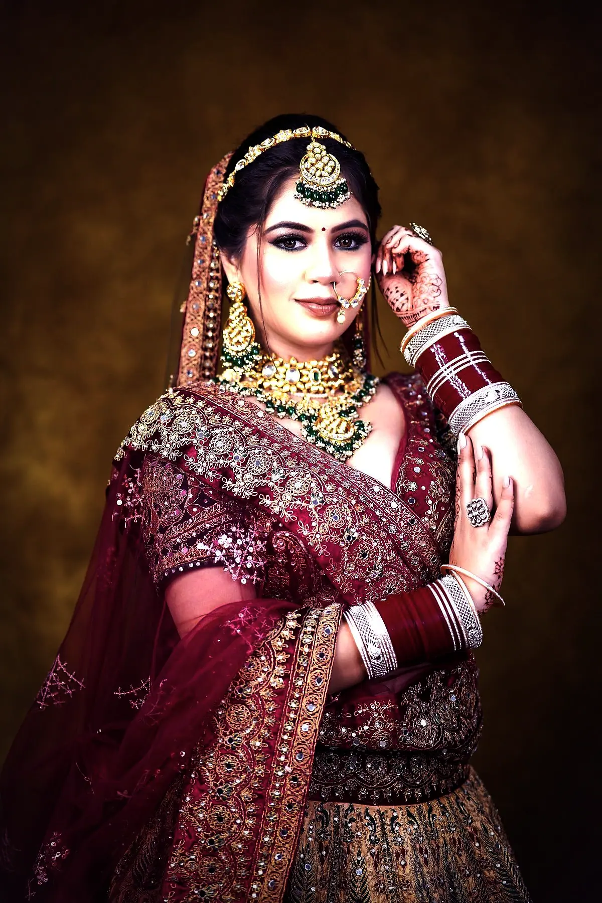 Sruthi at her reception in an imperial plum lehenga