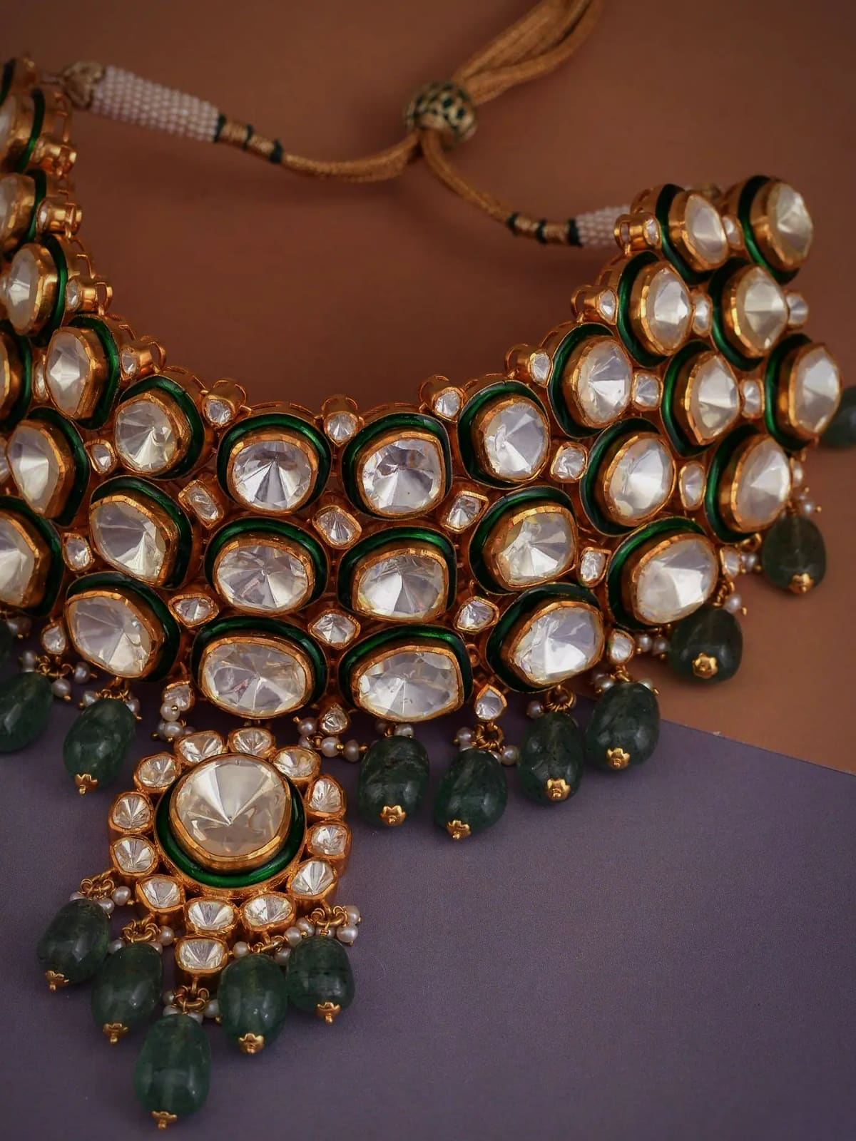 Kundan choker with emerald drops, photographed flat