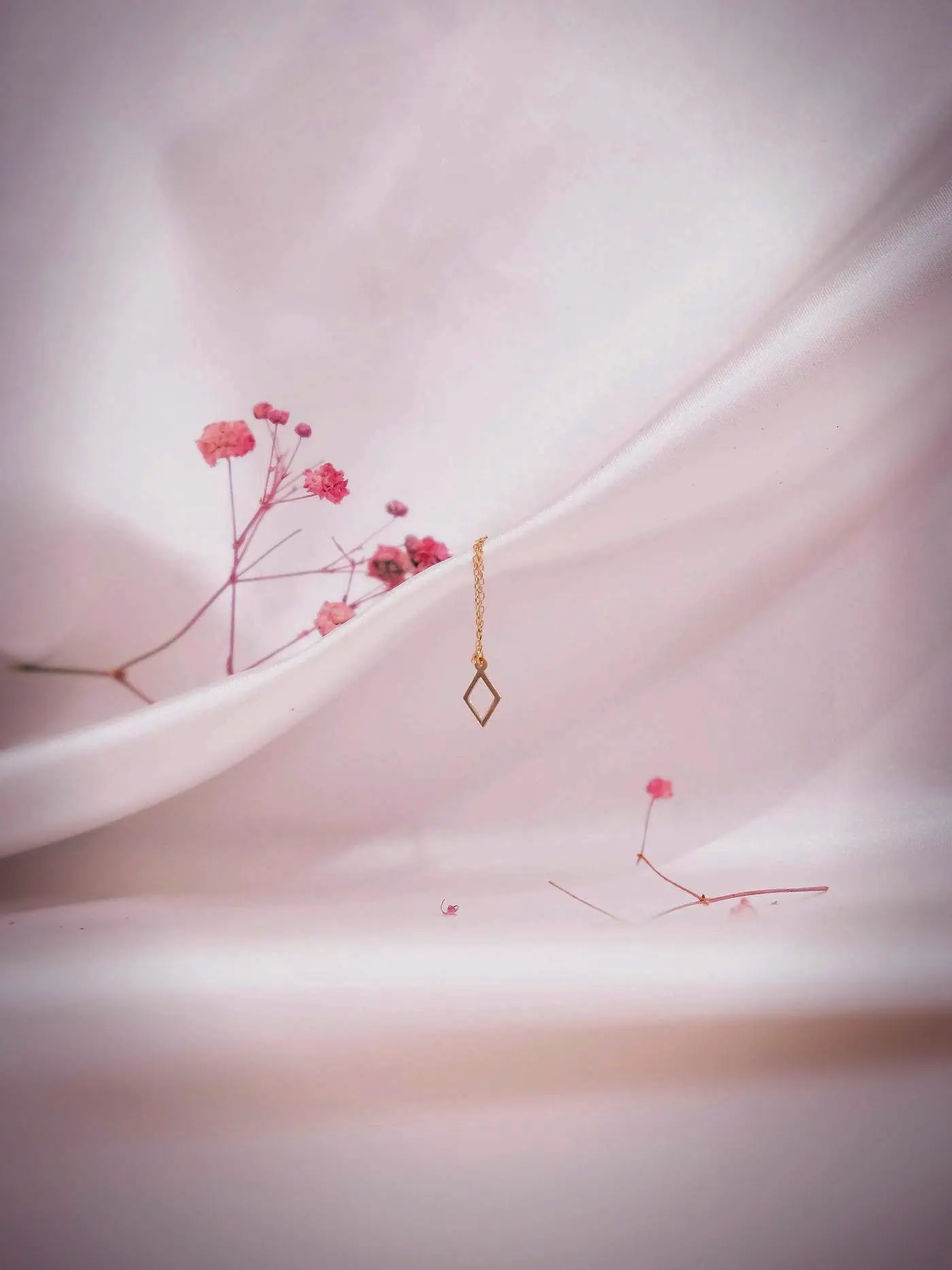 Fine gold pendant chain on blush silk