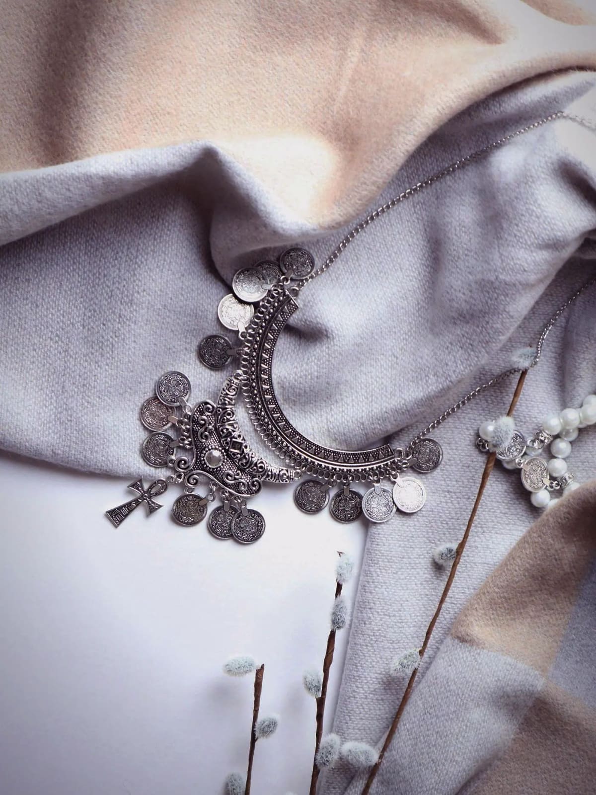 Coin kasu necklace laid on cloth